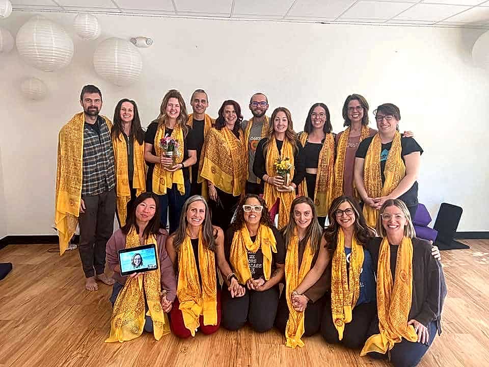 Image of 300 hour students wearing yellow sadhanas at the Pikes Peak studio