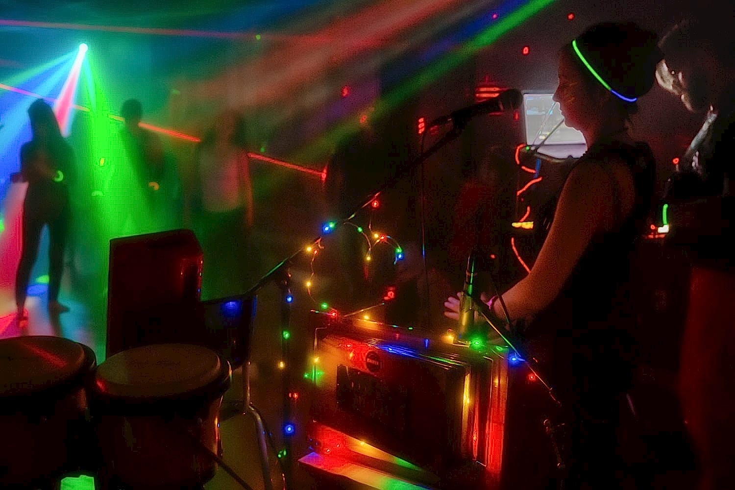 People dancing in cool lights and fog